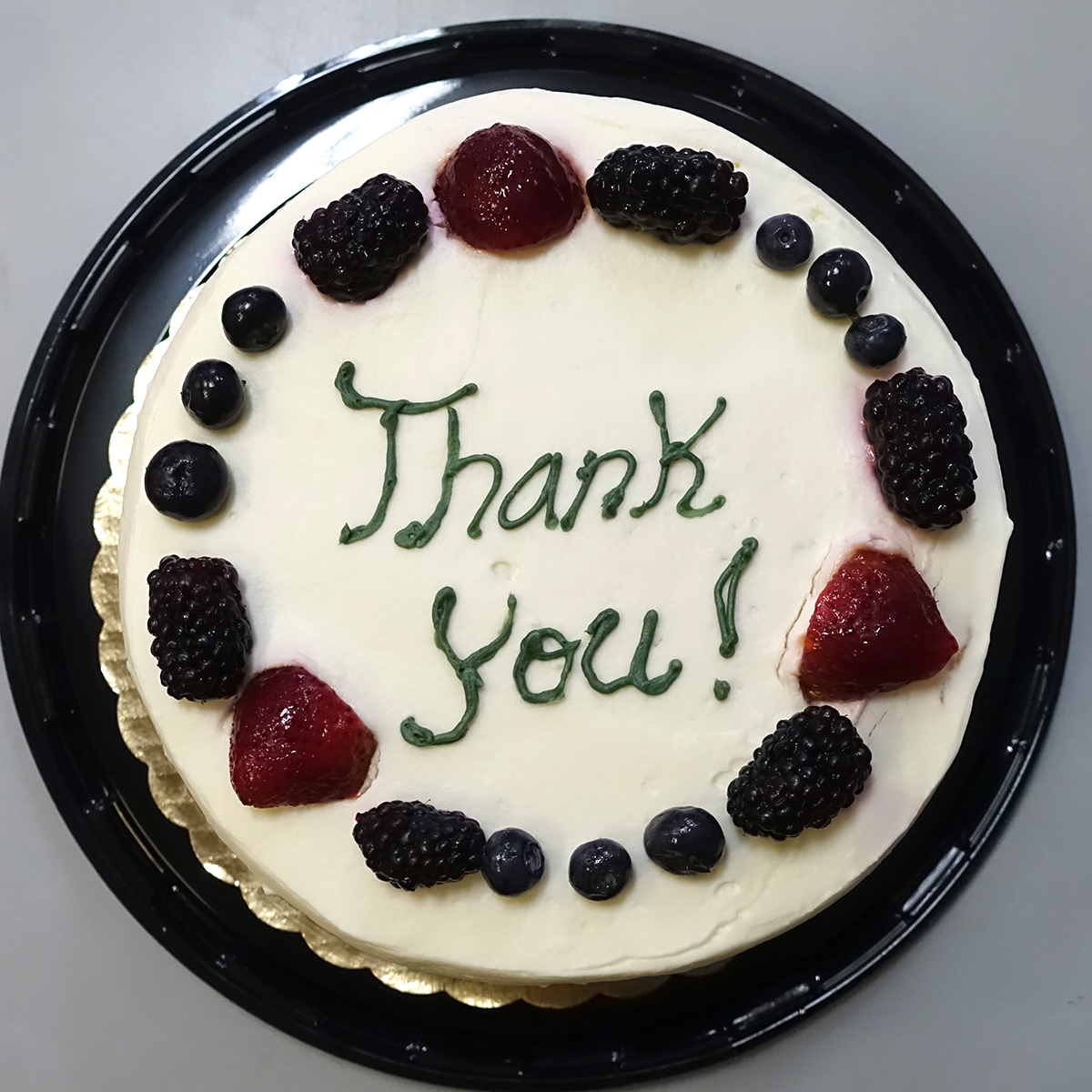 cake with thank you written in frosting