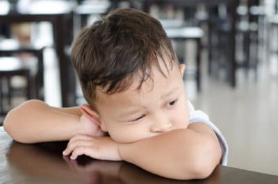 A young boy looks sad. 