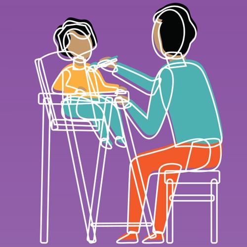 early brain development: baby eating in high chair
