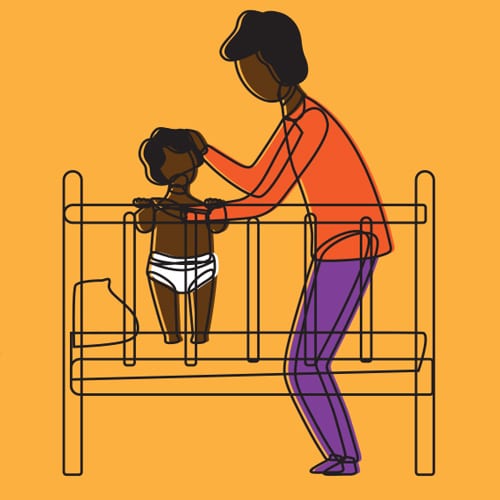 early brain development: child standing in crib with parent nearby