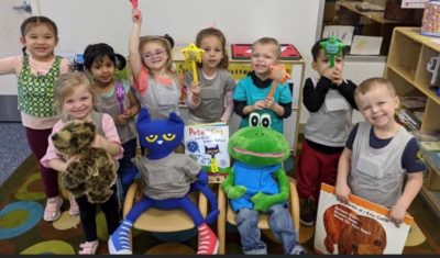 smiling preschoolers posing in a classroom