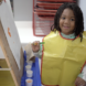 Preschooler in art smock smiling at the camera