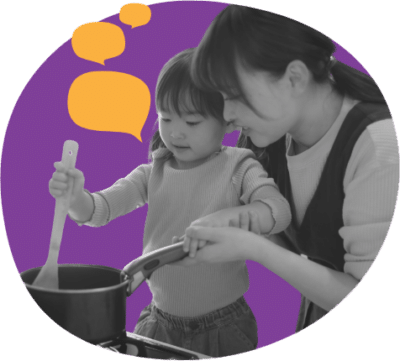 Female caregiver stirring pot with young girl. Pretend cooking or child is helping caregiver cook.