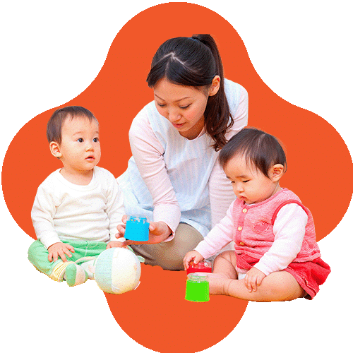 A woman sits with two toddlers, one in white and green and the other in pink, playing with colorful cups against an orange, rounded background shape.
