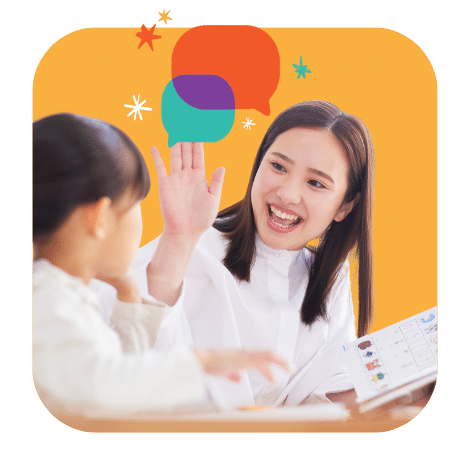 A woman smiles and gives a high-five to a child while holding a communication board, with colorful speech bubble graphics in the background.