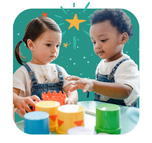 Two young children in denim overalls play with colorful stacking cups at a table, with a teal background featuring illustrated stars and sparkles.